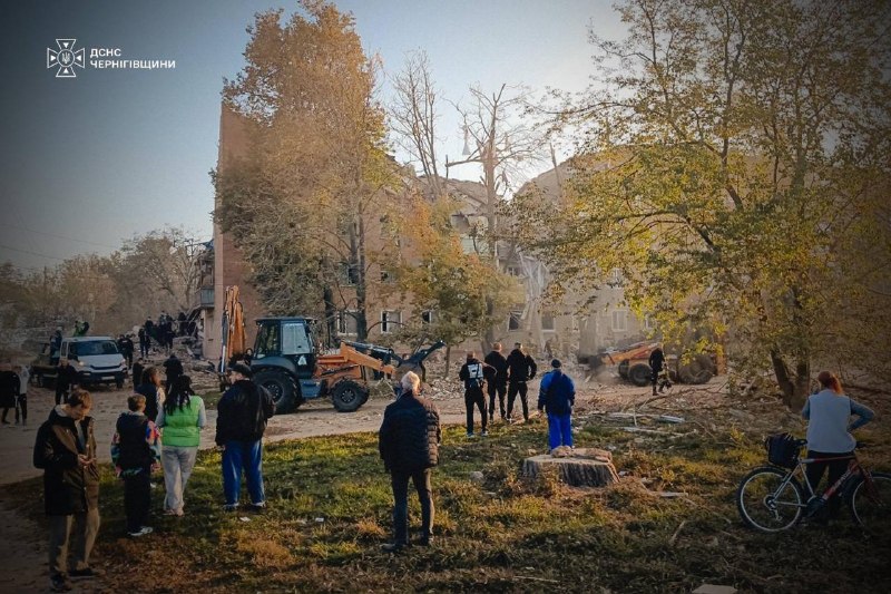 Rescuers work at the site of a missile strike on a residential building in Pryluky