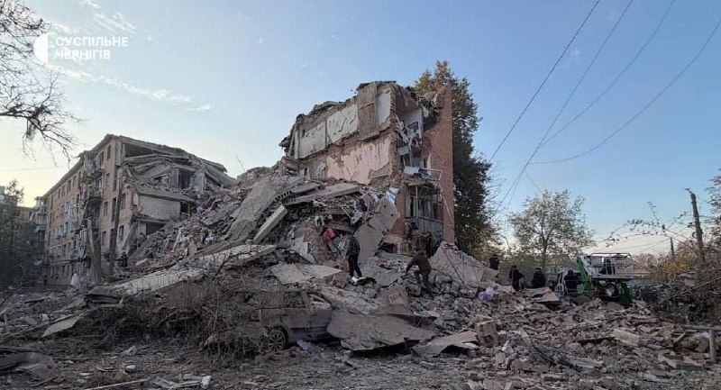 Rescuers work at the site of a missile strike on a residential building in Pryluky