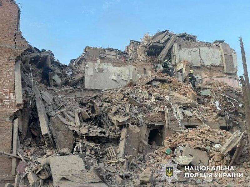 Rescuers work at the site of a missile strike on a residential building in Pryluky