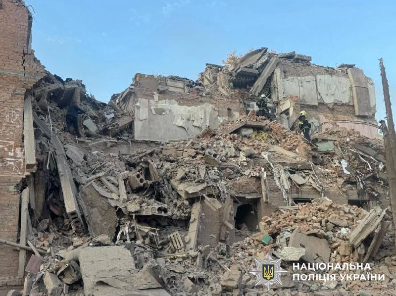 Rescuers work at the site of a missile strike on a residential building in Pryluky