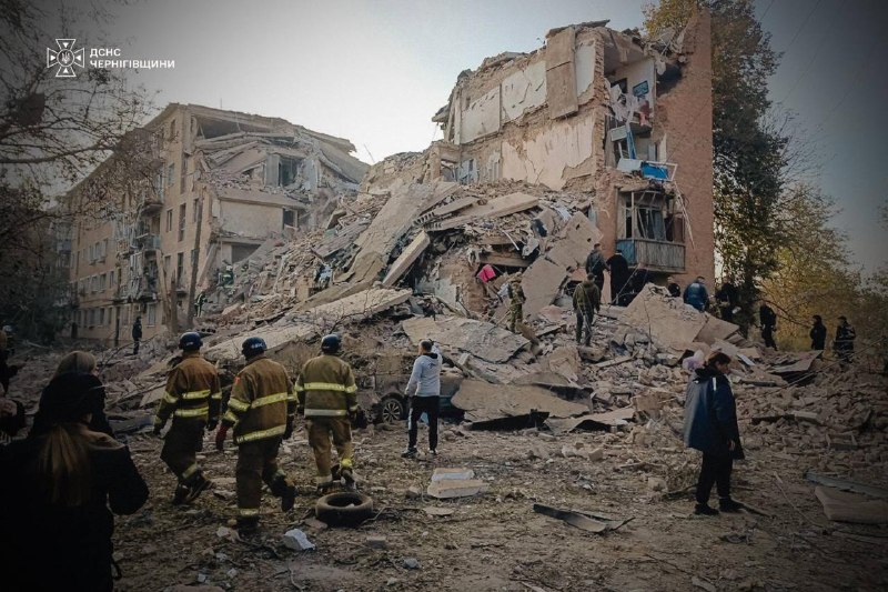 Rescuers work at the site of a missile strike on a residential building in Pryluky