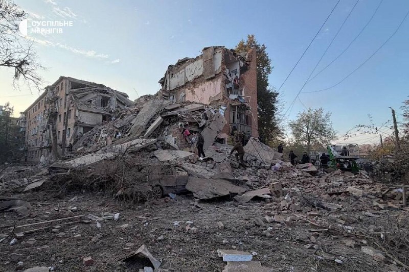 Rescuers work at the site of a missile strike on a residential building in Pryluky