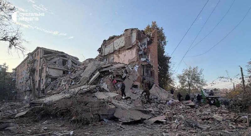 Rescuers work at the site of a missile strike on a residential building in Pryluky