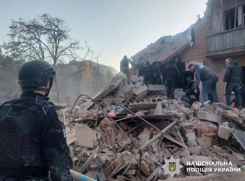 Rescuers work at the site of a missile strike on a residential building in Pryluky