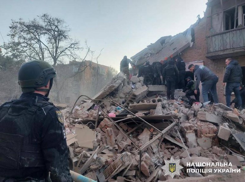 Rescuers work at the site of a missile strike on a residential building in Pryluky