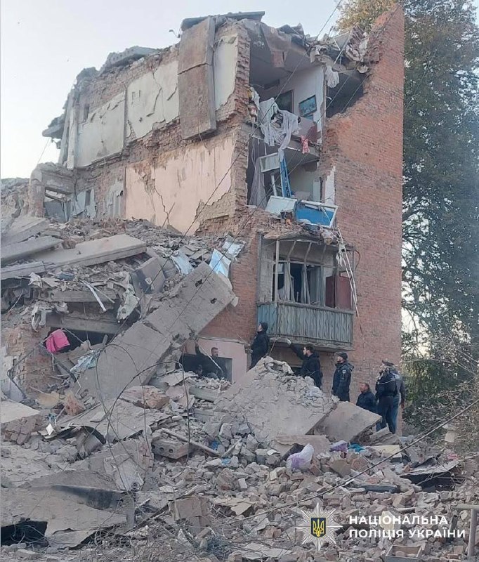 Rescuers work at the site of a missile strike on a residential building in Pryluky