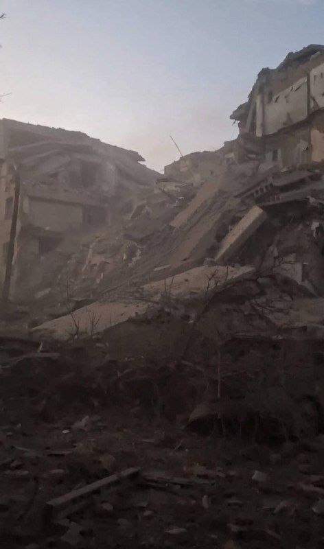 Rescuers work at the site of a missile strike on a residential building in Pryluky
