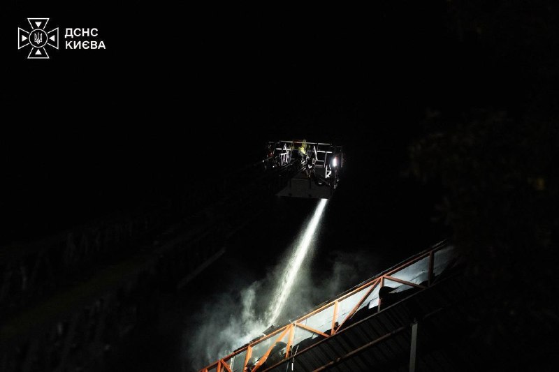 Rescuers work at the site of a strike in Kyiv