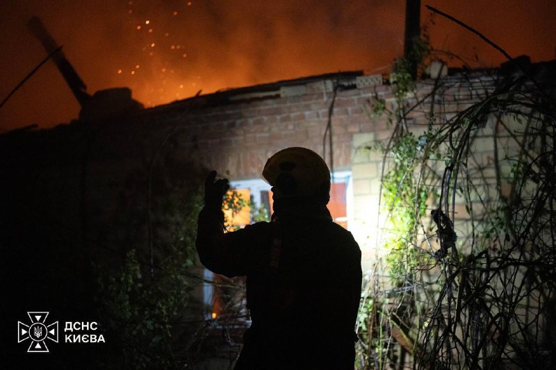 Rescuers work at the site of a strike in Kyiv