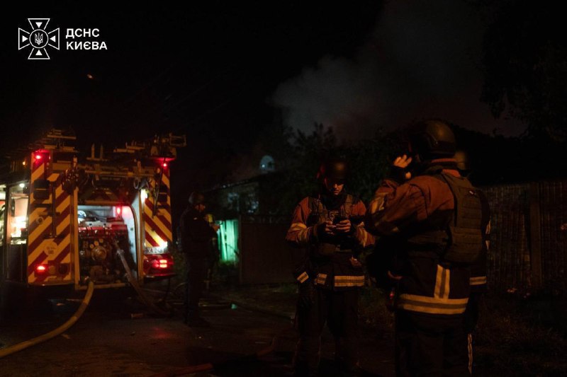 Rescuers work at the site of a strike in Kyiv