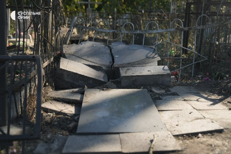People at the central cemetery in Sumy after an aerial strike