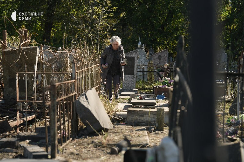 People at the central cemetery in Sumy after an aerial strike