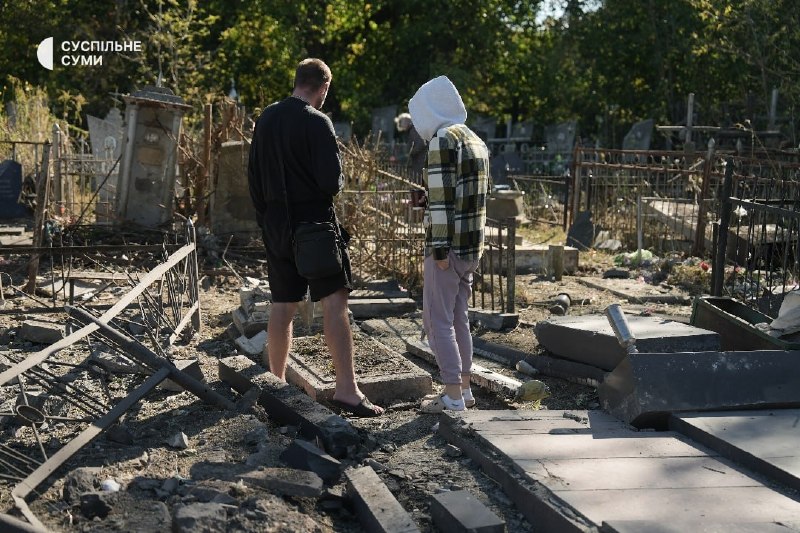People at the central cemetery in Sumy after an aerial strike
