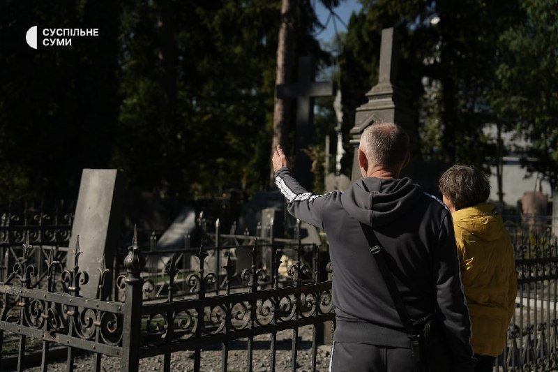 People at the central cemetery in Sumy after an aerial strike