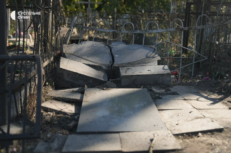 People at the central cemetery in Sumy after an aerial strike