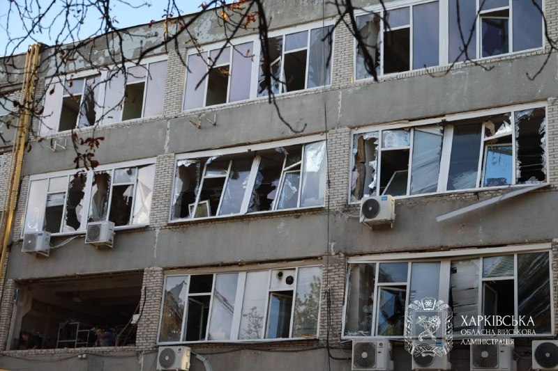 Rescuers and police officers work at the site of a strike in Kharkiv Oblast