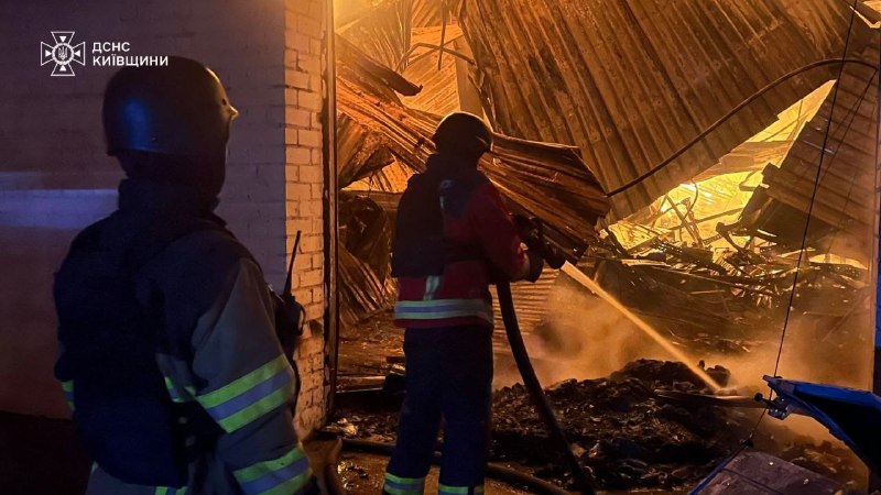 Rescuers extinguish a fire after a strike