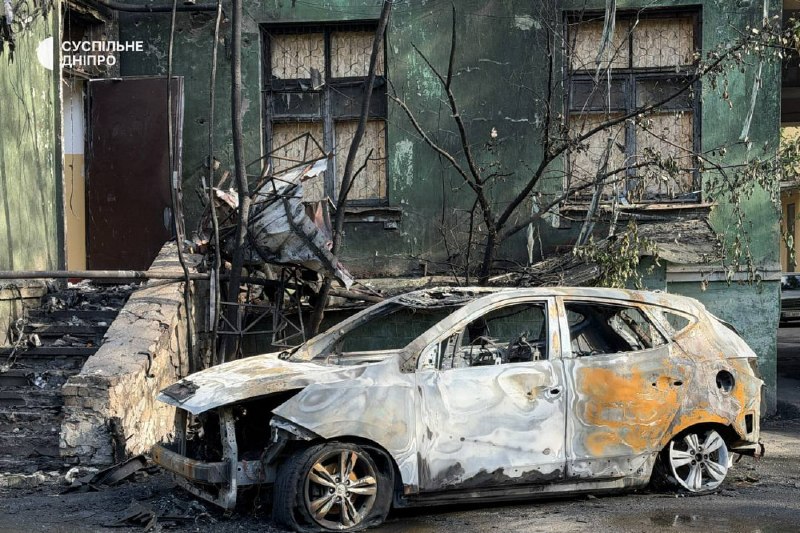 Rescuers and municipal workers operate at the site of a multi-storey building strike in Dnipro